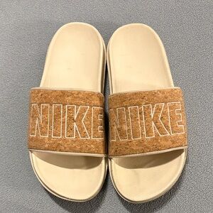 Nike women’s slides size 7 cork strap and tan foot bed.